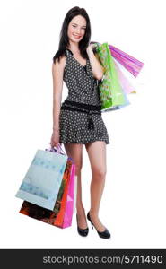 Pretty young woman standing isolated on white with color bags