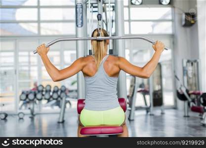 Pretty young woman training in the gym