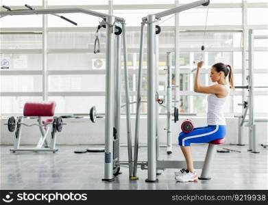 Pretty young woman training in the gym