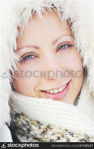 pretty young woman wearing winter outfit with fur portrait
