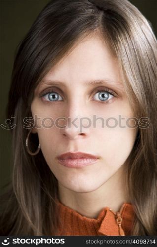 Pretty young woman with a blank expression on her face