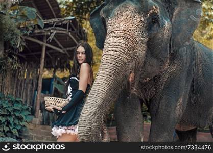 Pretty, young woman with an elephant