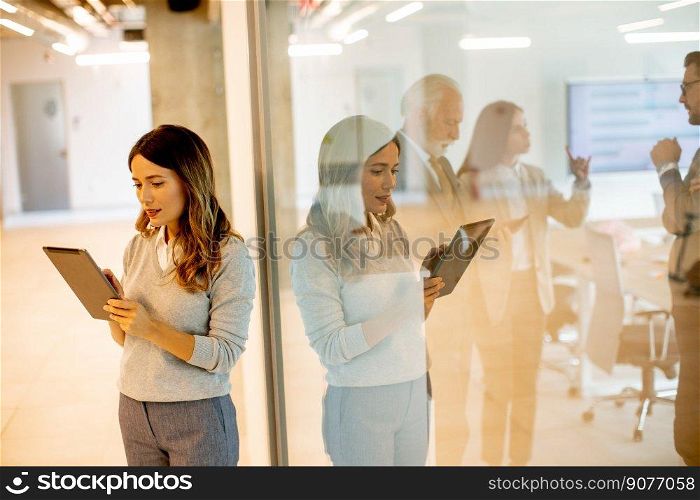 Pretty young woman with digital tablet in the office