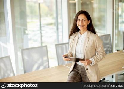 Pretty young woman with digital tablet in the office