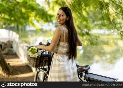 Pretty young woman with flowers in the basket of electric bike