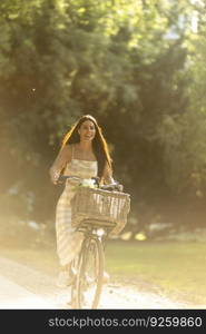 Pretty young woman with flowers in the basket of electric bike