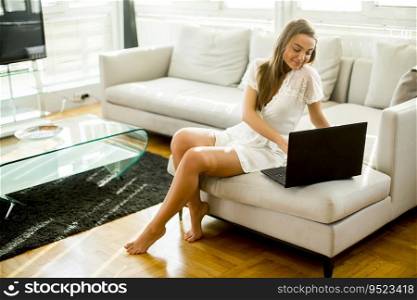 Pretty young woman with laptop in the room