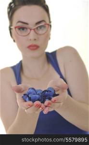 pretty young woman with red eyeglassess hold blue flower petals ins hands isolated on white