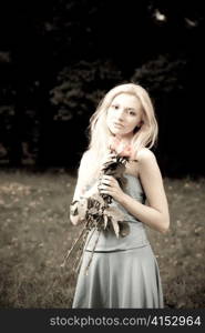 Pretty Young Woman With Roses In Hands