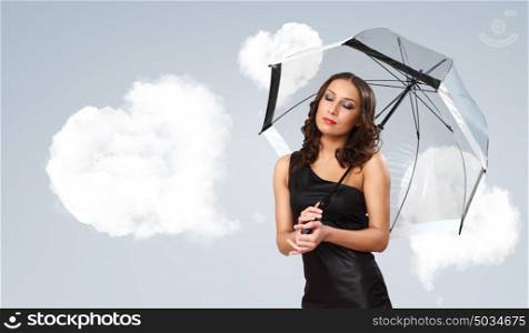 Pretty young woman with umbrella and with hearts on the background