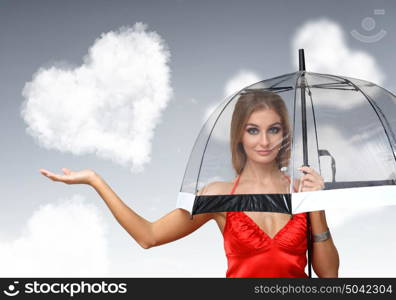 Pretty young woman with umbrella and with hearts on the background