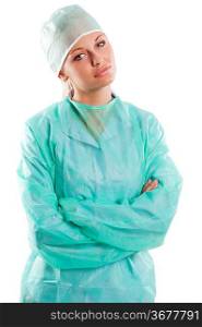 prety nurse in green surgery dress and a cap looking in camera over white