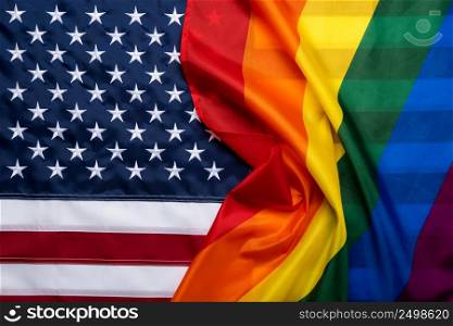 Pride rainbow lgbt gay flag over American US flag . Equality diversity freedom in USA concept.