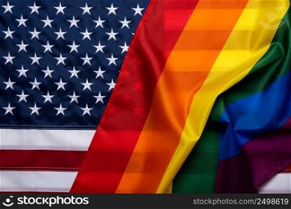 Pride rainbow lgbt gay flag over American US flag . Equality freedom in USA concept.
