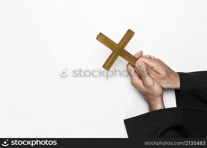 priest holding holy cross hands