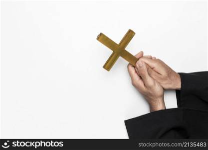 priest holding holy cross hands