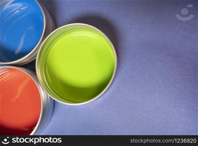 Primary colors in acrylic paint in metal tins still life art supply