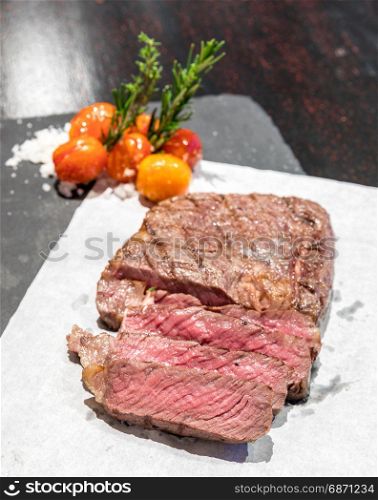 Prime tenderloin beef steak served with grilled tomato with sea salt