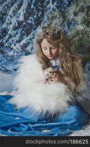Princess hand with a live ferret in his hands.. Child at the Christmas tree with the ferret in his hands 4578.