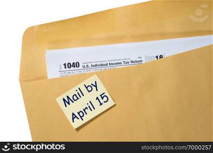 Printed copy of Form 1040 for income tax return for 2018 with reminder for April 15, 2019 deadline. Tax Day reminder for April 15 on envelope