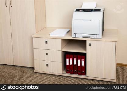 printer from the cabinet in a modern office