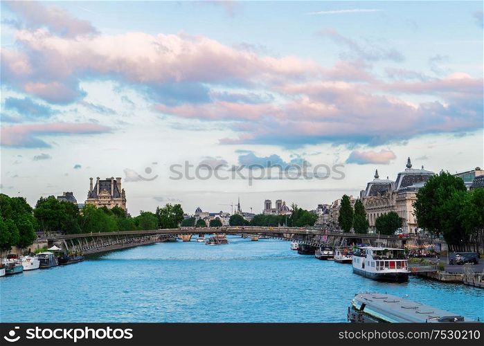 Pris cityscape with Notre Dam spires, Orsay museum, Louvre, passerelle Leopold Senghorl and river Siene at summer, Paris, France. Orsay museum and river Siene, France