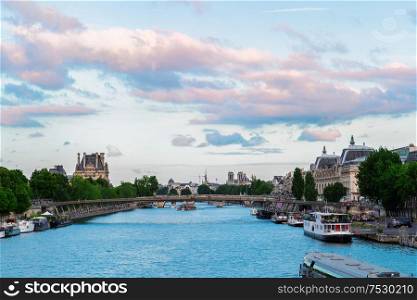 Pris cityscape with Notre Dam spires, Orsay museum, Louvre, passerelle Leopold Senghorl and river Siene at summer, Paris, France. Orsay museum and river Siene, France