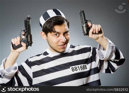 Prisoner with gun against dark background