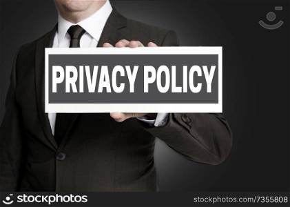 Privacy Policy sign is held by businessman.. Privacy Policy sign is held by businessman
