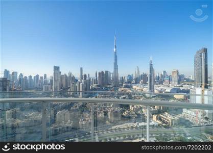 Private balcony or terrace at Burj Khalifa in hotel, Dubai Downtown skyline, United Arab Emirates or UAE. Financial district in smart urban city in travel trip and holidays vacation concept.