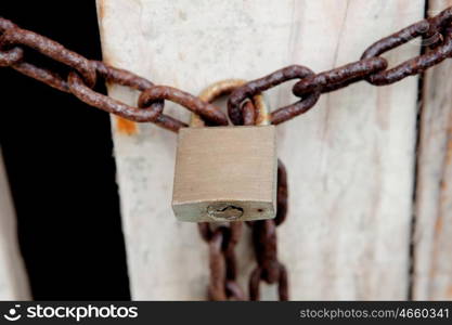 Private property. Closed padlock with rusty chain