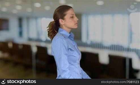 Pro female is very serious in an office