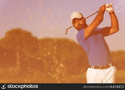 pro golf player shot ball from sand bunker at course. pro golfer hitting a sand bunker shot