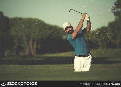 pro golf player shot ball from sand bunker at course. pro golfer hitting a sand bunker shot