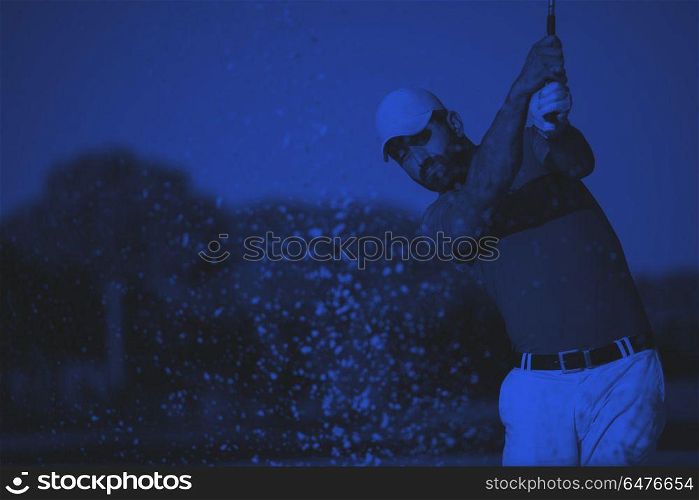 pro golfer hitting a sand bunker shot. pro golf player shot ball from sand bunker at course duo tone