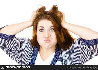 Problem expressions concept. Irritable attractive woman having angry wrathful frustrated face expression touching her hair. Attractive woman having angry frustrated face expression