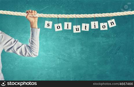 Problem solution. Word solution composed of cards hanging on rope