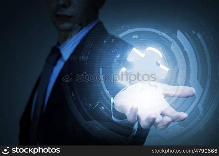 Problem solving. Close up of businessman holding puzzle element in palm