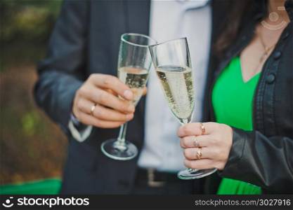 Process of a congratulation of the newly-married couple by wine drinks.. Glasses with champagne.