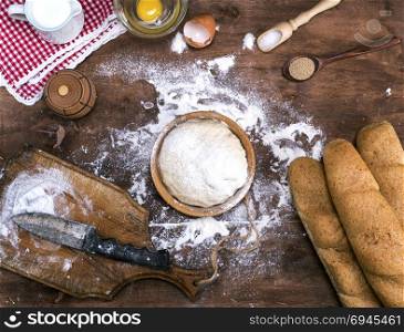 process of cooking bread from a yeast dough, near the ingredients, top view