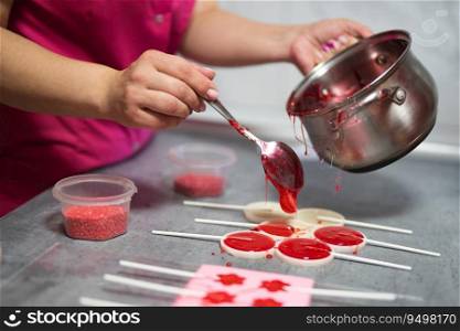 process of making delicious lollipops by pouring them into molds