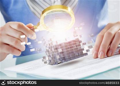 Process of new technologies intergration . Close up of business person examining digital cube with magnifier