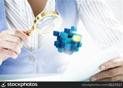 Process of new technologies intergration . Close up of business person examining digital cube with magnifier