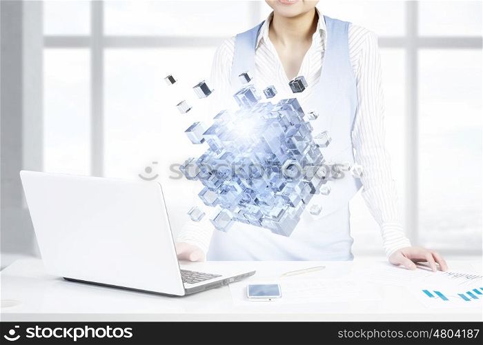 Process of new technologies intergration . Close up of business person working with laptop and digital levitating cube