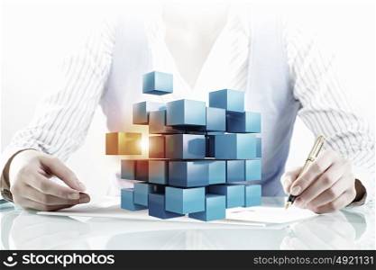 Process of new technologies intergration. Close view of businesswoman working on laptop and cube figure as technology concept