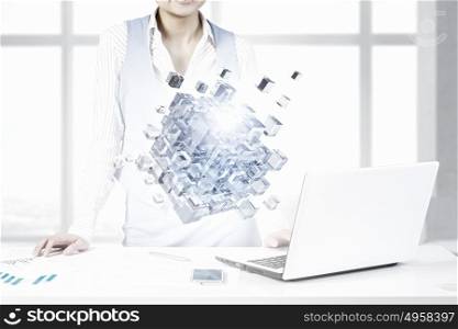 Process of new technologies intergration. Close view of businesswoman working on laptop and 3D illustration cube figure as technology concept