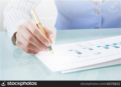 Process of new technologies intergration. Close view of businesswoman writing on papers and 3D illustration cube figure as technology concept