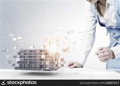Process of new technologies intergration. Close view of businesswoman writing on papers and 3D illustration cube figure as technology concept