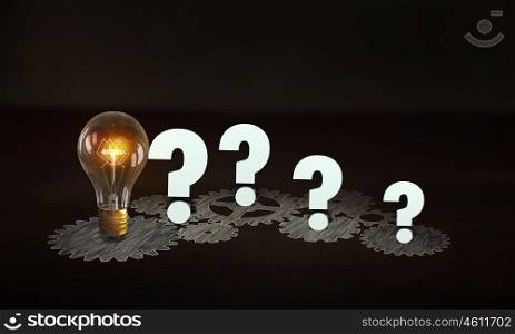 Producing energy. Glowing light bulb and gears mechanism on dark background