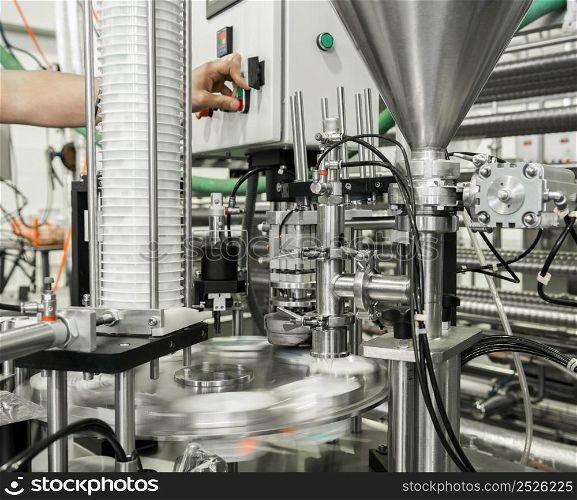 production and bottling of yogurt in plastic cups. equipment at the dairy plant. equipment at the milk factory